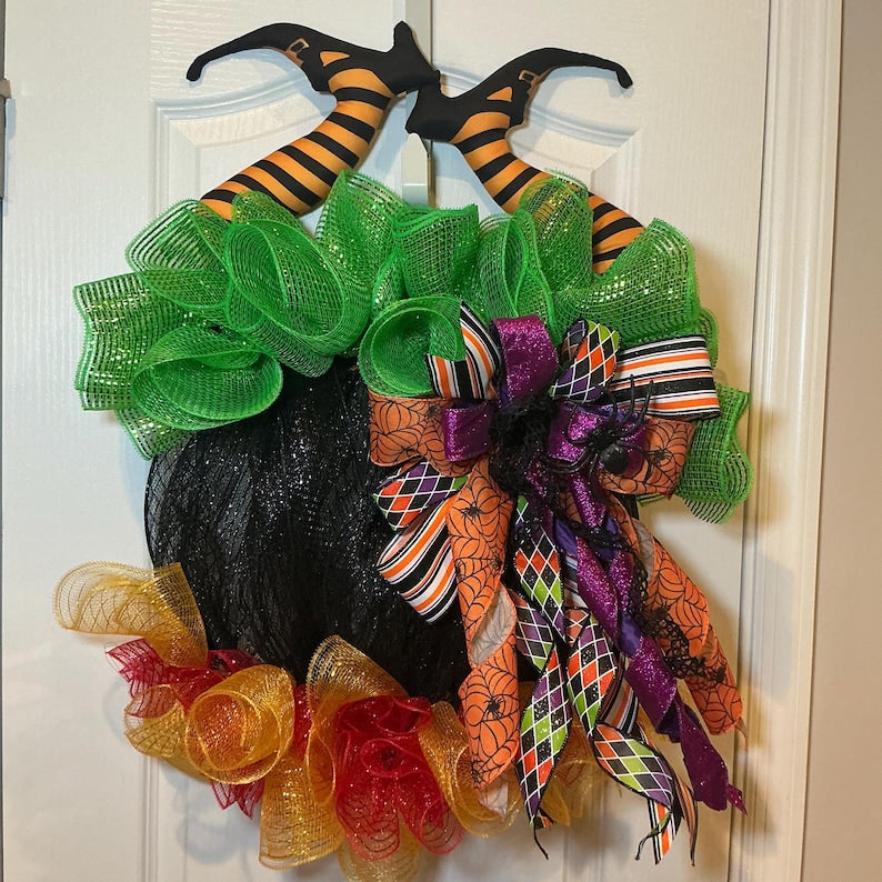 Actual front photograph of Halloween cauldron wreath with witch legs