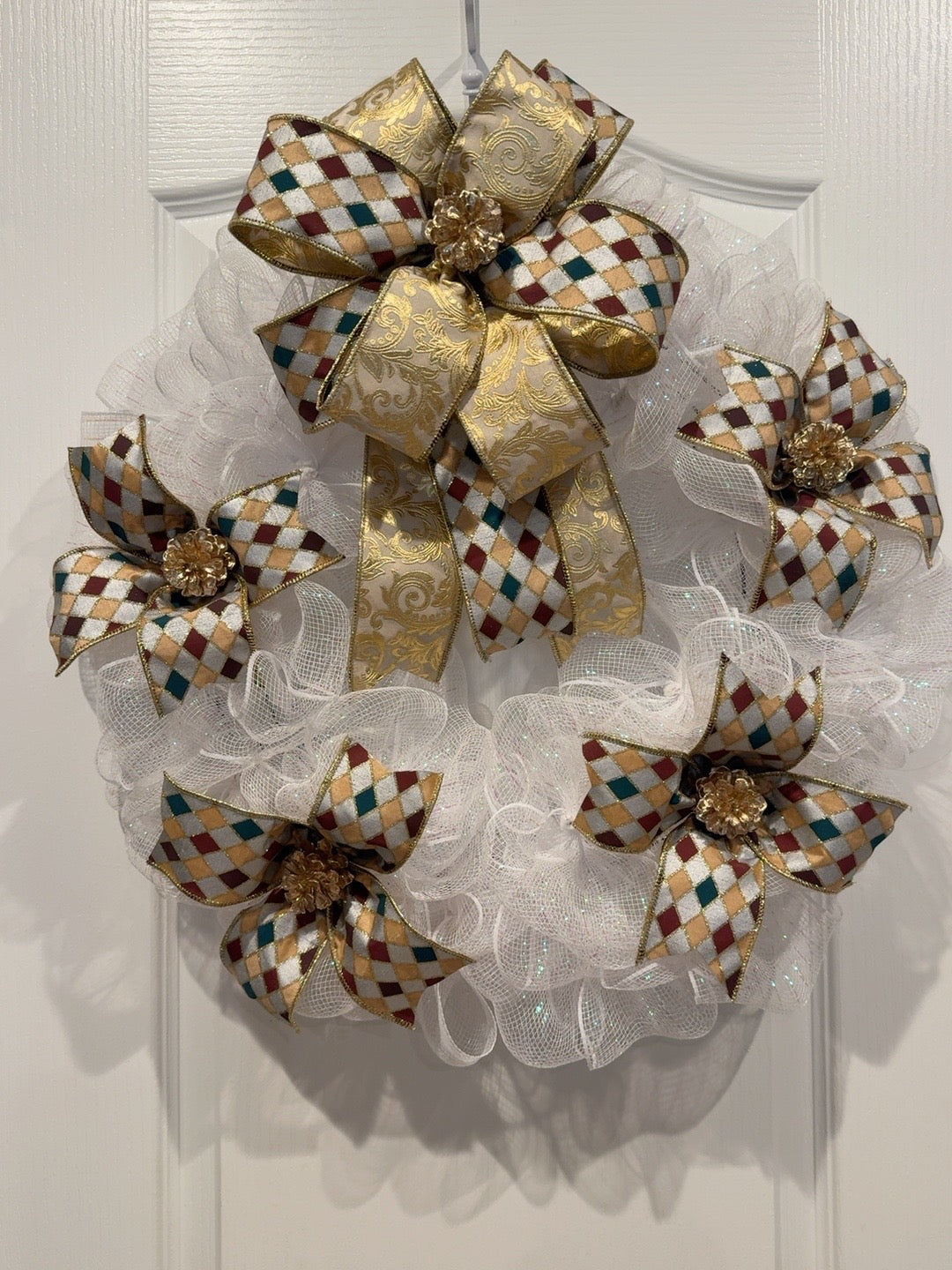 Front view of white deco mesh Christmas wreath with gold, burgundy, and teal diamond ribbon