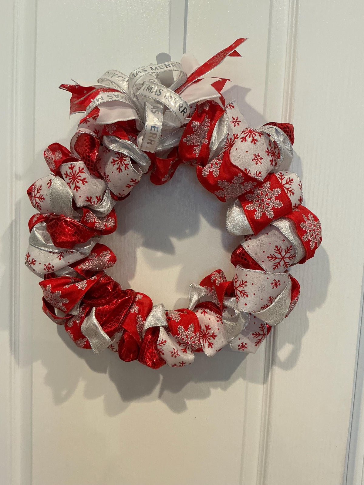 14 Inch Snowflake Christmas Wreath: Red, Silver Ribbon Door Decor — actual product photo