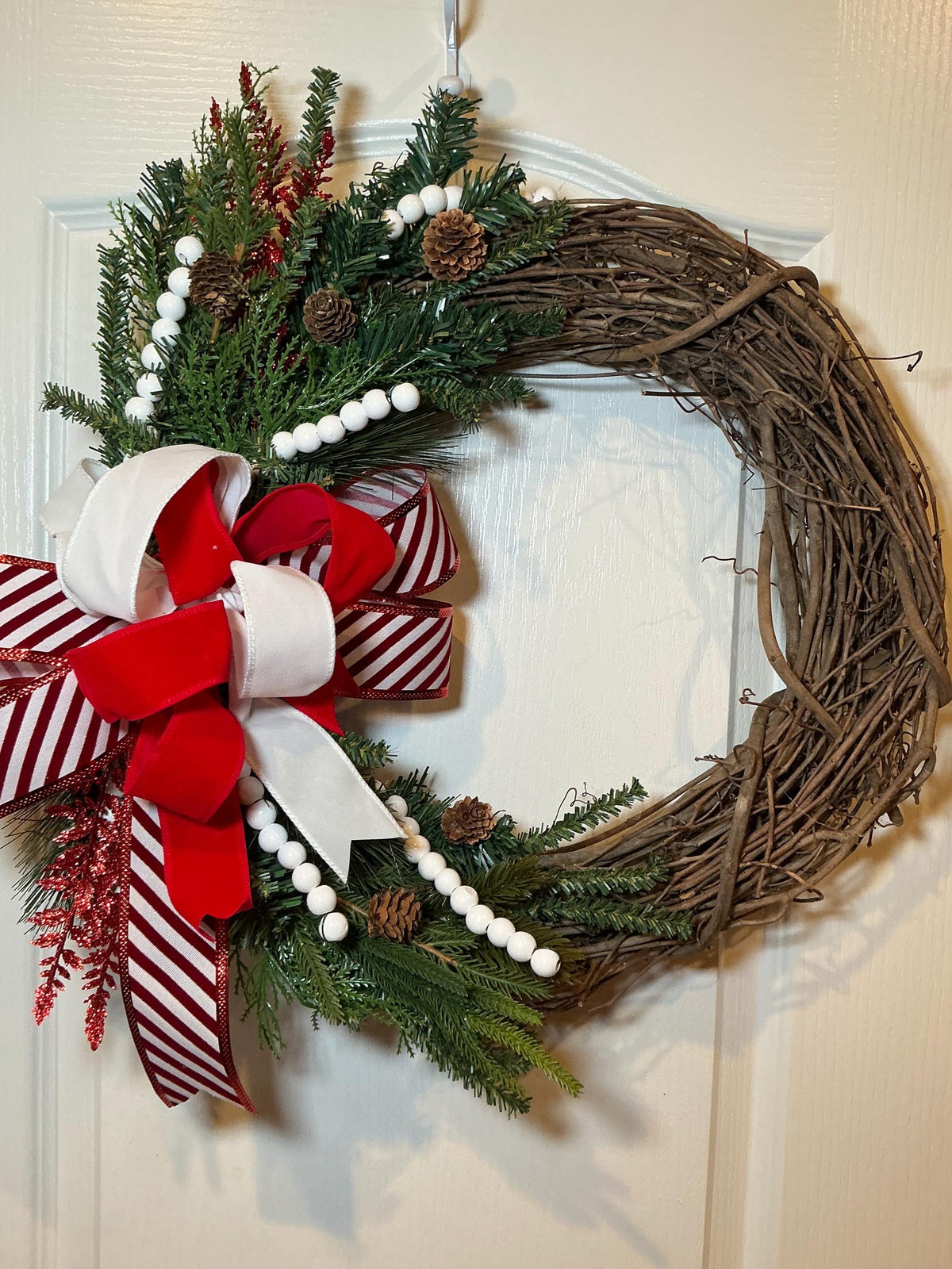 Grapevine Christmas Wreath, Candy Cane Bow, Pinecones, White Beads, Farmhouse Holiday Door Decoration. — actual product photo