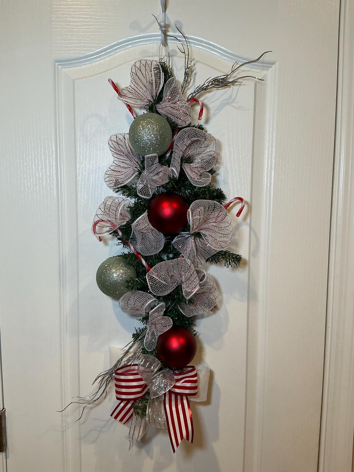 Handcrafted 24 Inch Candy Cane Christmas Swag, Red White Holiday Door Decor — actual product photo