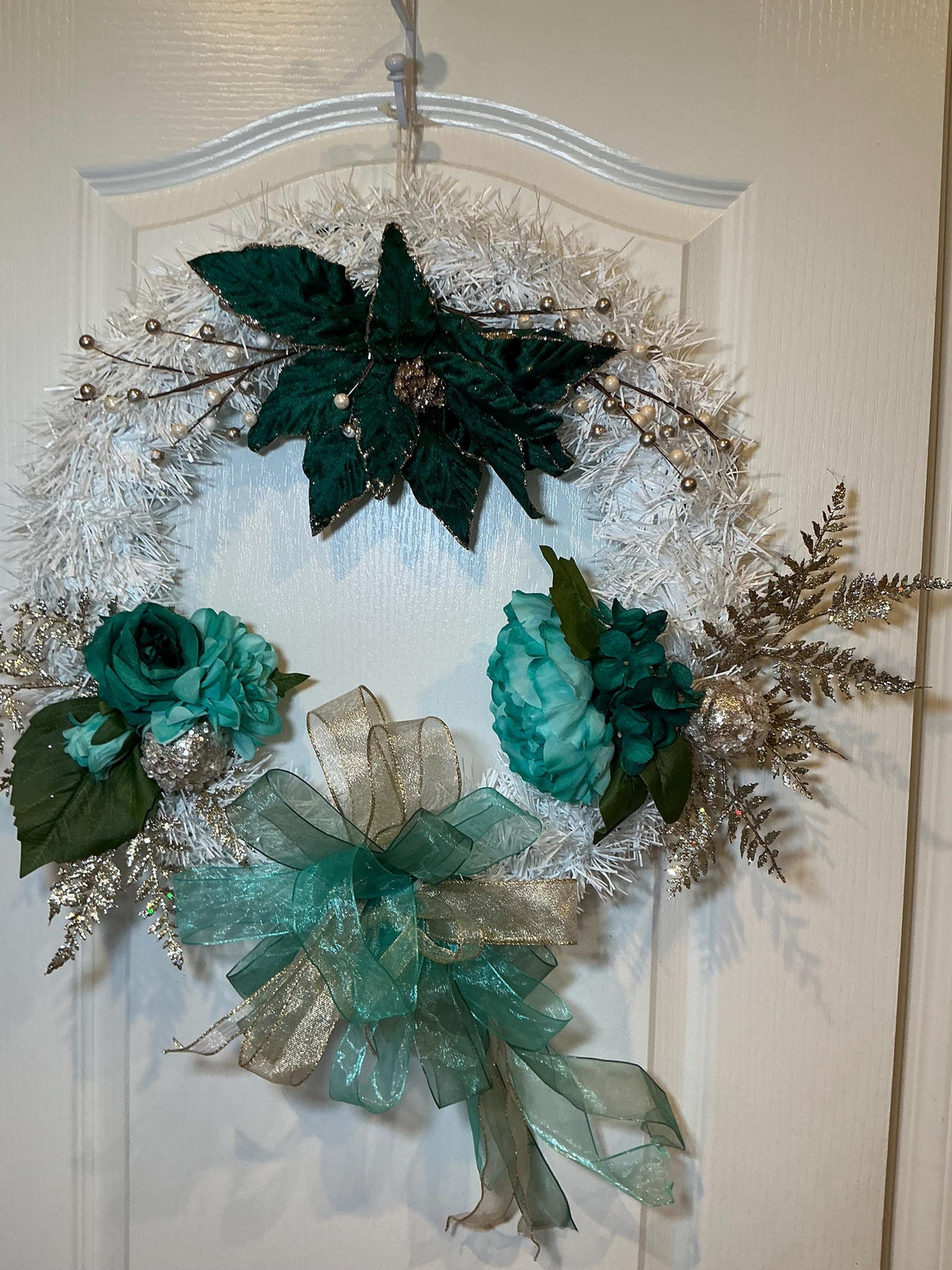 18 Inch White Evergreen Christmas Wreath, Emerald Poinsettia, Teal Roses, Gold Bow — actual product photo