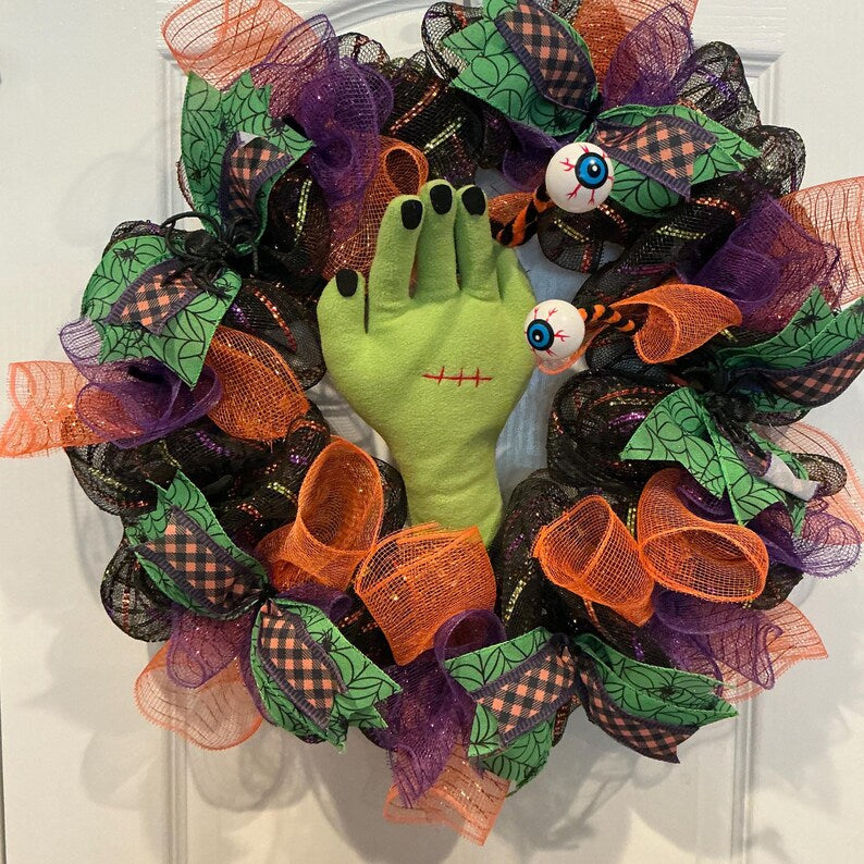 Actual front photograph of Frankenstein monster hand Halloween wreath