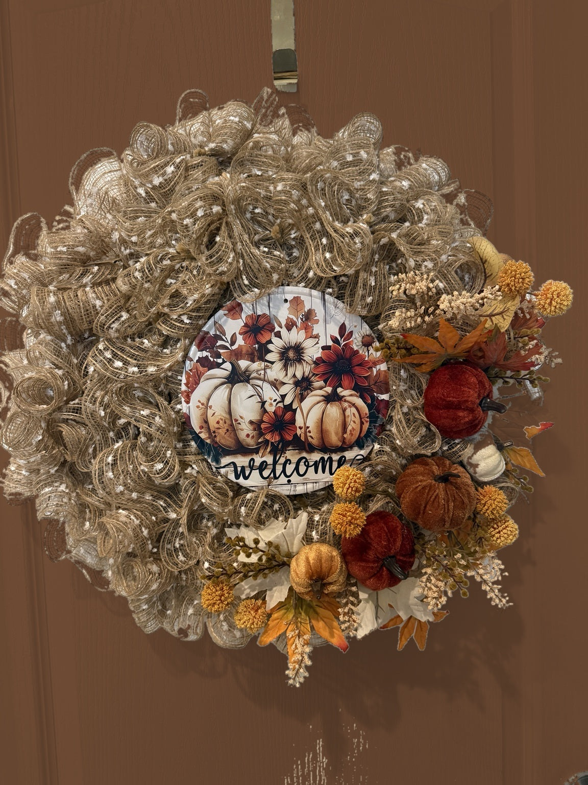 Welcome to Fall wreath on brown door, front view